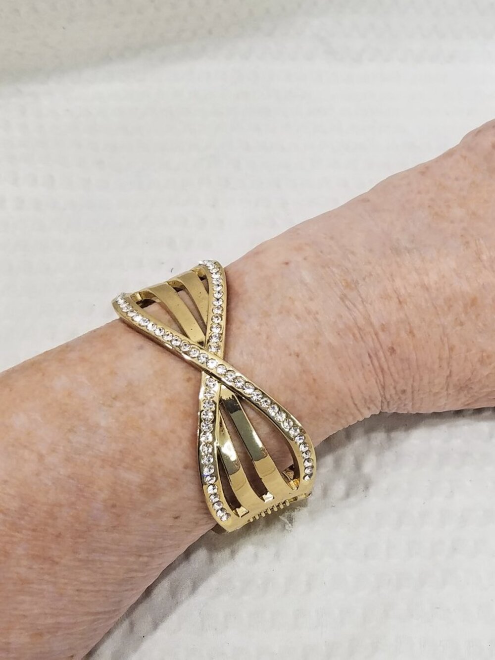 Gold Tone Criss Cross Hinged Clamper Bracelet with White Crystals – Oval Design